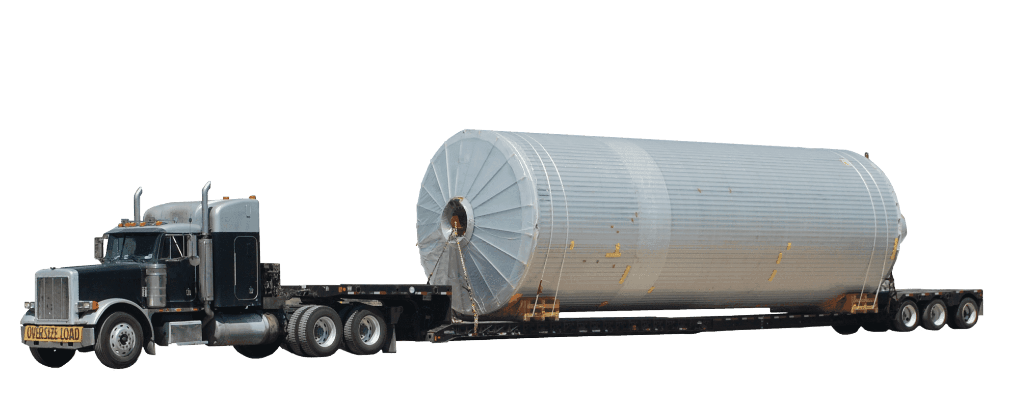 A side view of an overdimensional freight truck carrying an extremely oversized load on a low bed.