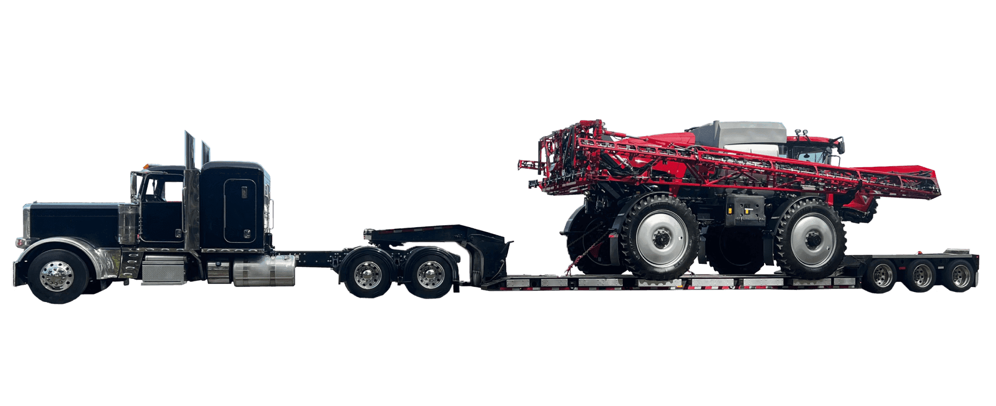 A red vehicle strapped to an oversized truck's low bed.